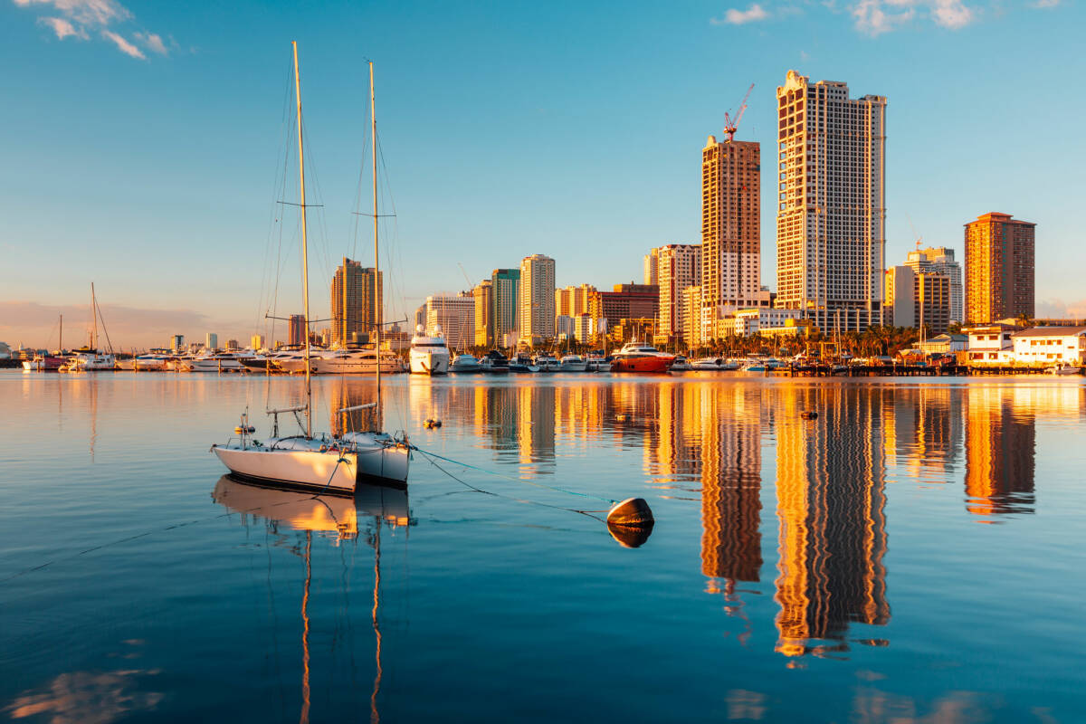 View of skyscrapers and their reflection on the lake in Manila Bay Manila Philippines