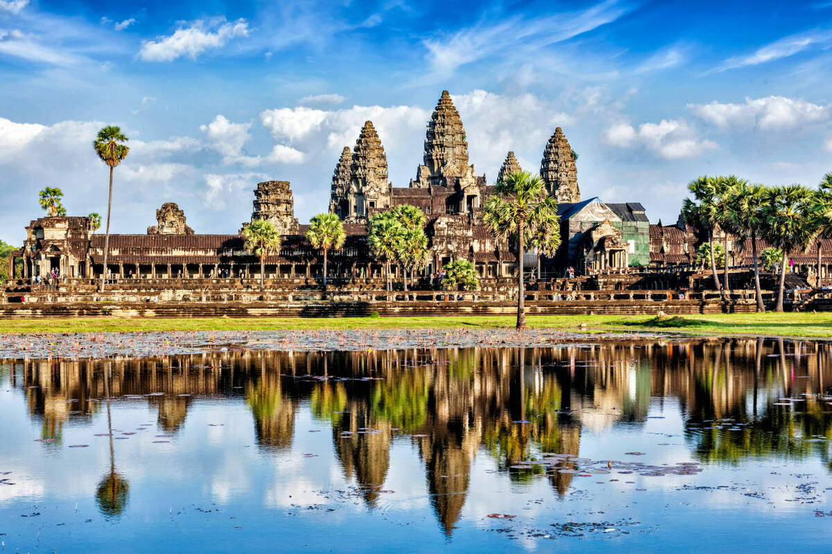 The view of Cambodia landmark Angkor Wat with reflection in the water.