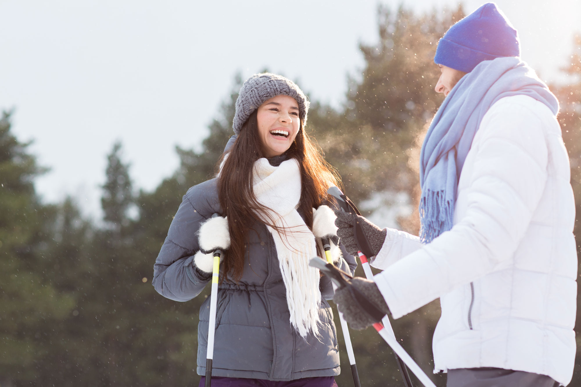 Skiing couple enjoying their trip with ski travel insurance.